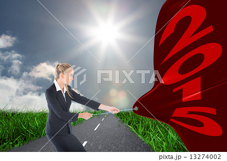 Composite image of focused blonde businesswoman pulling a rope Composite image of focused blonde businesswoman pulling a rope 13274002