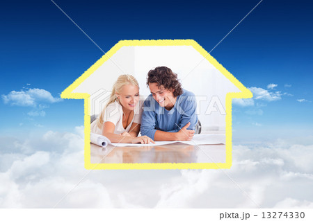 Composite image of smiling couple getting ready to move in a new 13274330