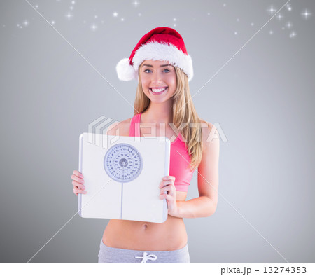 Composite image of festive fit blonde showing scales Composite image of festive fit blonde showing scales 13274353