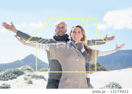 Composite image of carefree couple standing on the beach in warm Composite image of carefree couple standing on the beach in warm 13274922