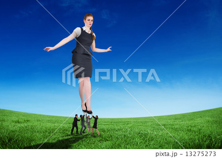 Composite image of business people supporting boss Composite image of business people supporting boss 13275273