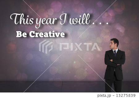 Composite image of businessman standing and looking 13275839