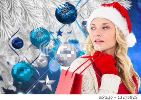Composite image of happy festive blonde with shopping bag 13275925