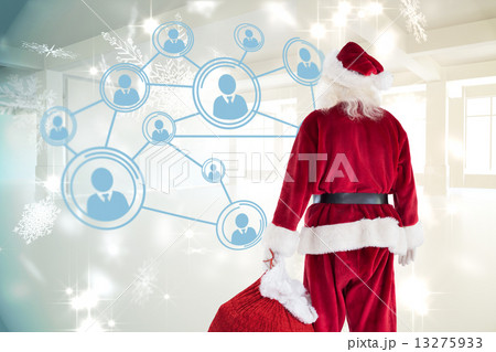 Composite image of santa carrying sack of gifts 13275933