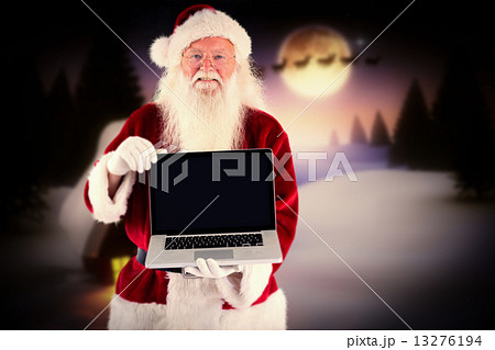 Composite image of santa claus presents a laptop Composite image of santa claus presents a laptop 13276194