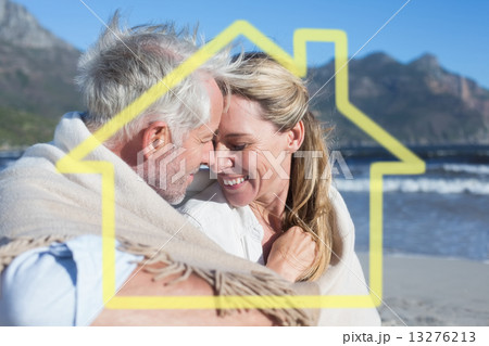 Composite image of smiling couple sitting on the beach under bla Composite image of smiling couple sitting on the beach under bla 13276213