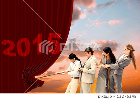 Composite image of boss pulling a rope against his employees 13276348