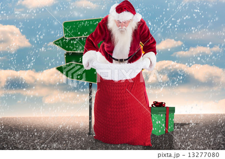 Composite image of santa looks in his bag 13277080