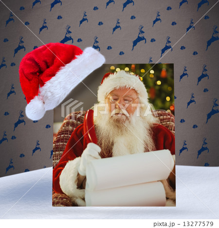 Composite image of santa claus writing his list with a quill Composite image of santa claus writing his list with a quill 13277579