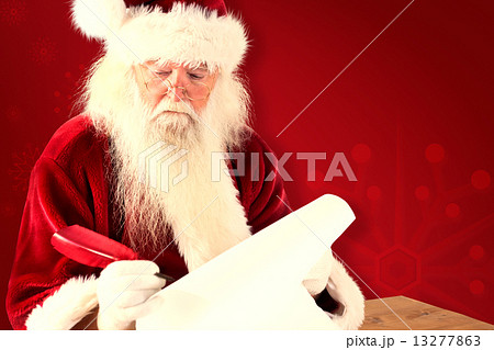 Composite image of santa writes something with a feather 13277863