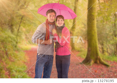 Composite image of couple standing underneath an umbrella Composite image of couple standing underneath an umbrella 13278195