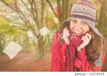 Composite image of cold redhead wearing coat and hat 13278329