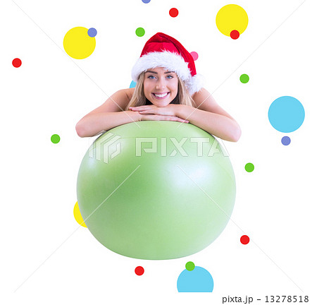 Composite image of festive fit blonde posing with exercise ball 13278518