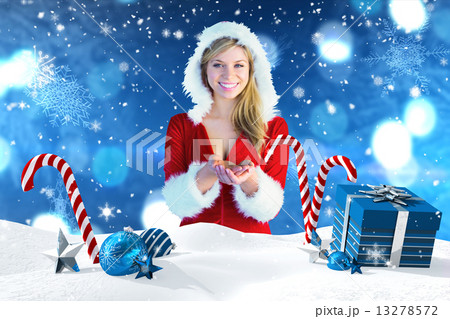 Composite image of pretty girl holding hands out in santa outfit Composite image of pretty girl holding hands out in santa outfit 13278572