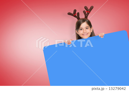 Composite image of festive little girl showing card 13279042