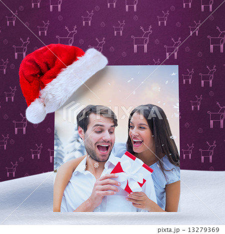 Composite image of woman surprising boyfriend with gift 13279369