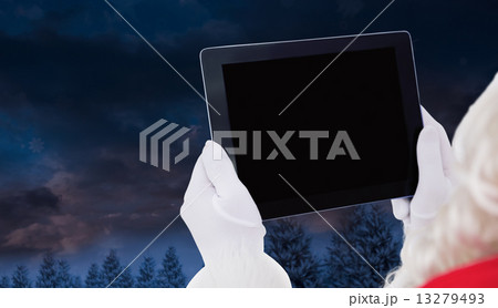 Composite image of santa claus using tablet pc Composite image of santa claus using tablet pc 13279493