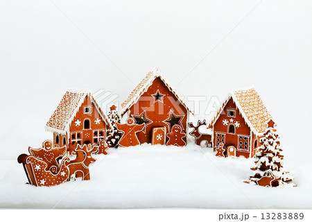 The family near hand-made eatable gingerbread house and New Year The family near hand-made eatable gingerbread house and New Year 13283889