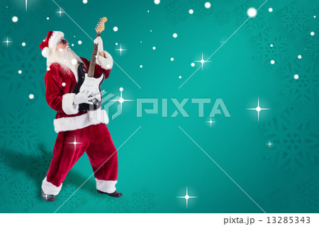Composite image of santa playing electric guitar Composite image of santa playing electric guitar 13285343