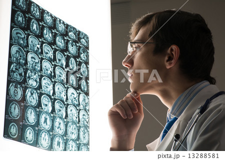 male doctor looking at the x-ray image male doctor looking at the x-ray image 13288581