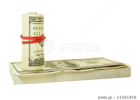 Roll of US dollars tied up with rubber on the stack of bills Roll of US dollars tied up with rubber on the stack of bills 13301956