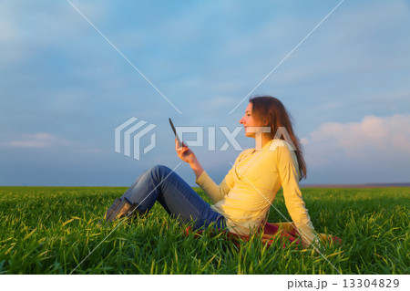 Teen girl reading electronic book 13304829