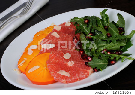 Salad of grapefruit, persimmon, pomegranate and rocket salad Salad of grapefruit, persimmon, pomegranate and rocket salad 13311655