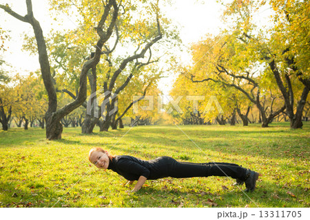 Woman doing yoga in autumn park Woman doing yoga in autumn park 13311705