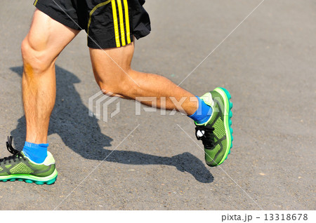 marathon athlete legs running on city road marathon athlete legs running on city road 13318678