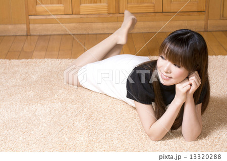 ラグマットの上でうつ伏せになる女性 13320288