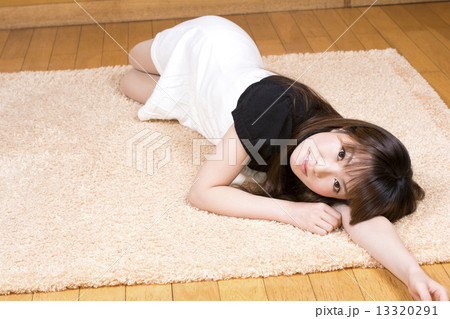 ラグマットの上で寝転がる女性 13320291