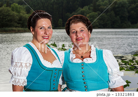 Two happy Bavarian ladies in dirndls Two happy Bavarian ladies in dirndls 13321863
