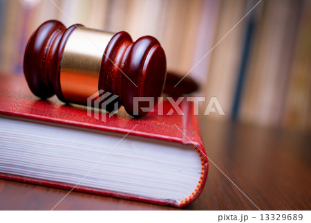 Judges gavel resting on a law book Judges gavel resting on a law book 13329689