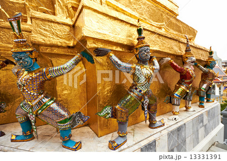 Colorful demons supporting golden stupa 13331391