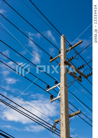 electrical post by the road with power line cables 13334434