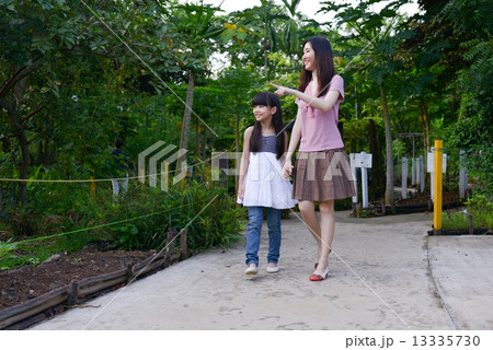 Mother and daughter in a garden Mother and daughter in a garden 13335730