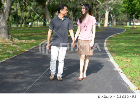 Married couple strolling in the park Married couple strolling in the park 13335793