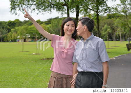 Aging father and daughter strolling in the park Aging father and daughter strolling in the park 13335841