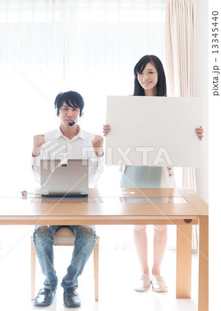 パソコン英会話　お勧めとガッツポーズをする若いカップル 13345440