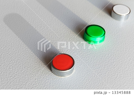 Three industrial buttons on gray control panel 13345888