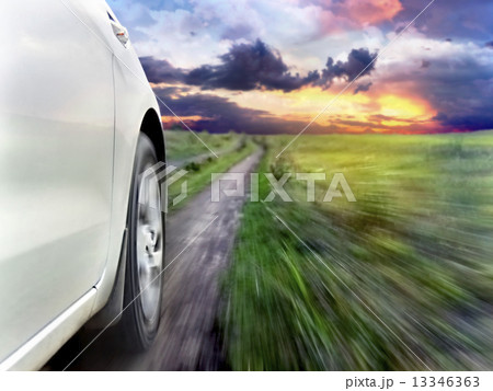 View of the front of a silver car while driving fast 13346363