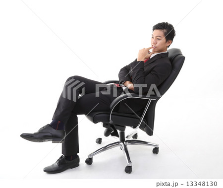 Man sitting and thinking on office chair Man sitting and thinking on office chair 13348130