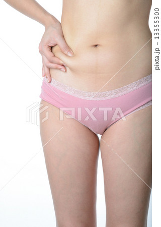 Beautiful slim woman checking her fat 13355300