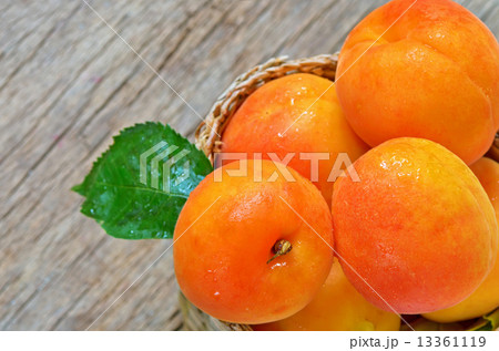 Apricots  on the old wooden table and basket 13361119