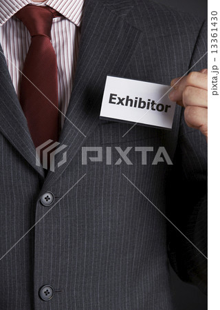 Businessman Attaching Exhibitor Badge To Jacket 13361430