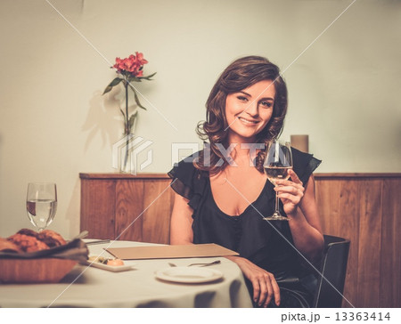 Beautiful young lady alone in restaurant Beautiful young lady alone in restaurant 13363414