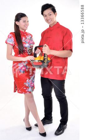 Traditional Chinese Man and Woman holding Basket of Mandarin Oranges with Good Fortune  13366588