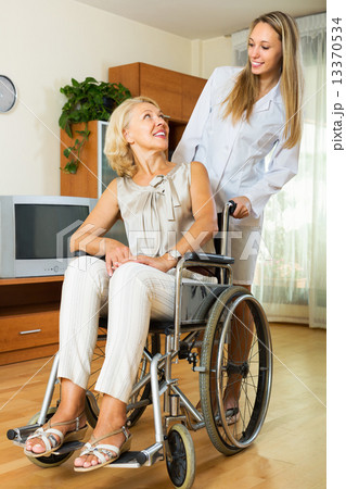 nurse and disabled woman on chair nurse and disabled woman on chair 13370534