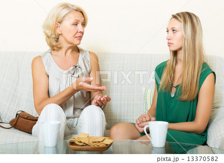 Serious mother and daughter talking 13370582