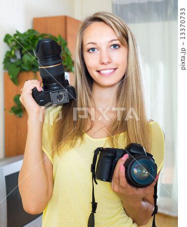 Girl testing professional cameras 13370733